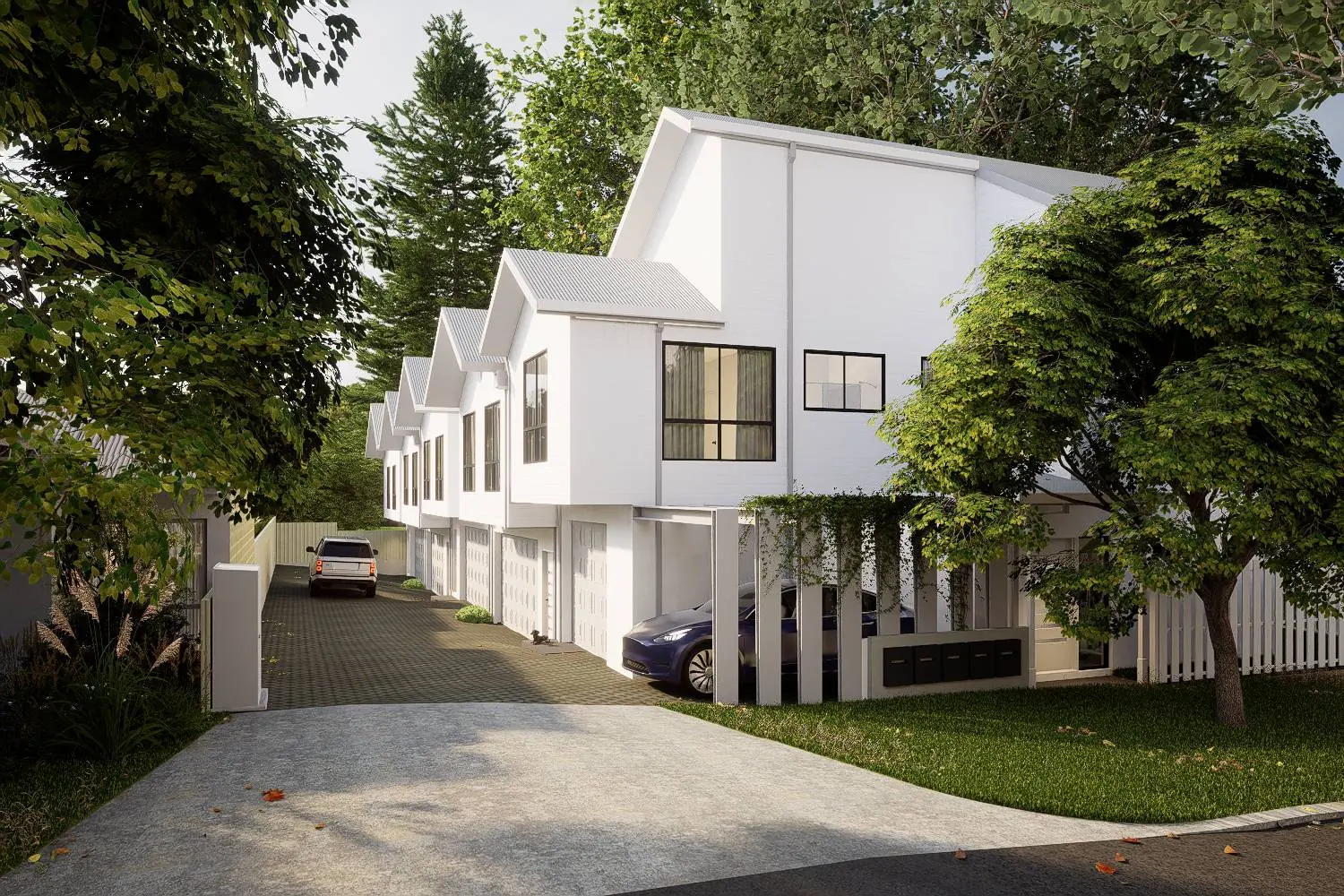 The shared driveway running beside the homes, with garage doors, established trees and a car parked under cover.